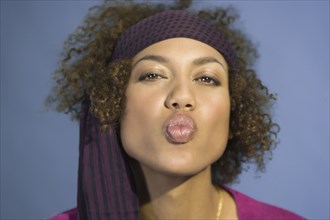 Mixed Race woman blowing kiss
