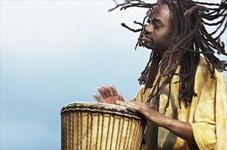 African man playing drum