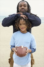 African father and son with football