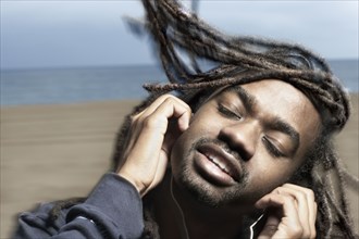 African man listening to headphones