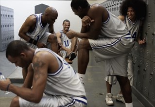 Multi-ethnic basketball players dressing in locker room