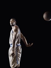 African basketball player passing basketball