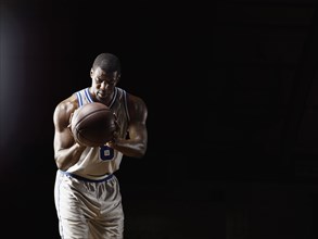 African basketball player holding basketball