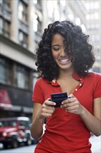 Mixed race teenage girl text messaging