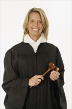 Studio shot of female judge holding gavel
