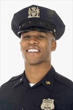 Studio shot of African male police officer smiling