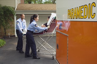 Paramedics putting woman into ambulance