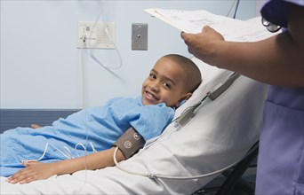 African boy smiling in hospital bed