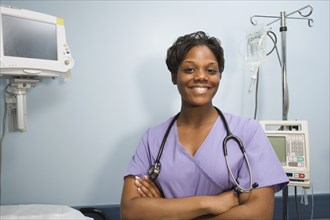 African female nurse smiling in hospital room