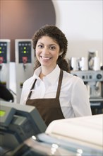 Mixed Race woman working at cafe