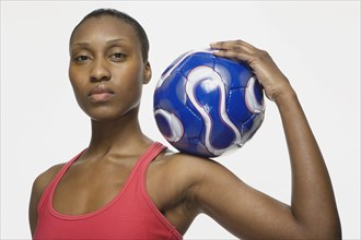 African American woman holding soccer ball