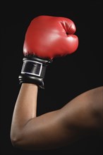 African American woman wearing boxing glove