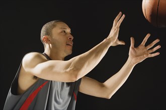 Mixed Race man playing basketball