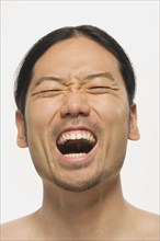 Close up of Asian man yelling