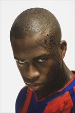 African American male soccer player with dirt on face