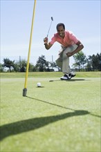 African man playing golf