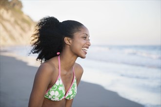 African woman laughing at beach