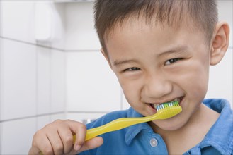 Chinese boy brushing teeth