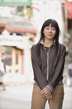 Chinese woman smiling on urban street