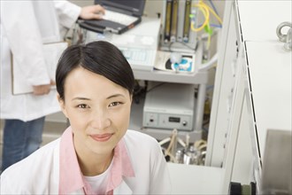 Chinese scientist in laboratory smiling