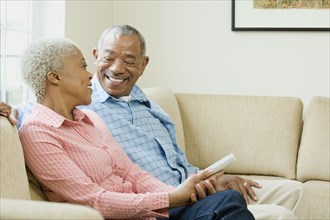 African couple watching television