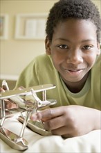 African American boy with model airplane