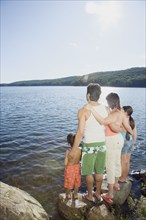 Family standing by lake