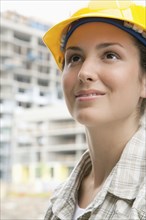 Mixed race woman in hard-hat on construction site