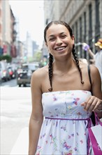 Hispanic woman smiling on urban street
