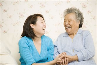 Chinese mother and daughter laughing