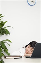 Chinese businesswoman sleeping at desk