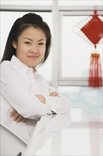 Chinese woman smiling at counter