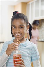 African girl drinking from curly straw