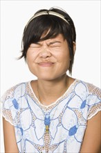 Asian woman scrunching face