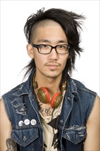 Asian man with headphones looking serious