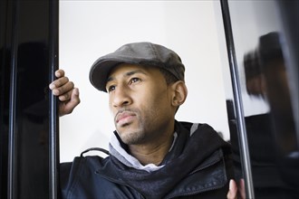 African American man wearing cap in doorway