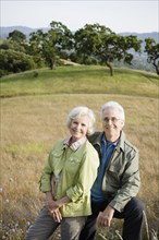 Caucasian couple standing in field