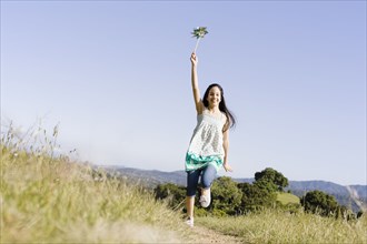 Hispanic girl running with pinwheel