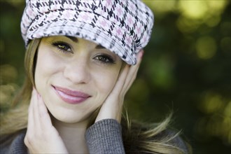 Hispanic woman in fashionable cap
