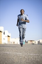 Black man running in parking lot