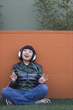 Asian woman listening to headphones