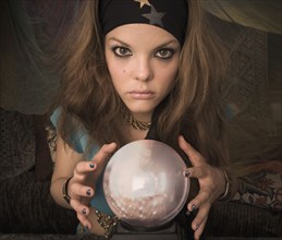Woman dressed at fortune teller with crystal ball