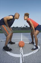 African man and woman on basketball court