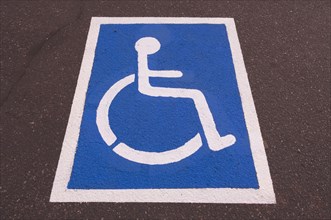 Handicapped symbol painted on pavement