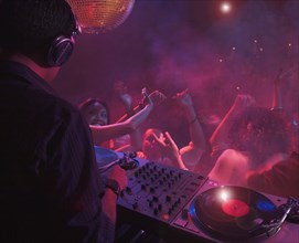 Hispanic dj playing at nightclub