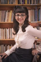 Portrait of woman wearing retro clothing in library