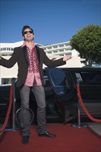 Hispanic man standing on red carpet