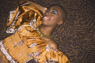 Bald African woman laying on floor