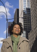 African American woman laughing in urban scene