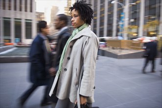 African American woman on urban sidewalk